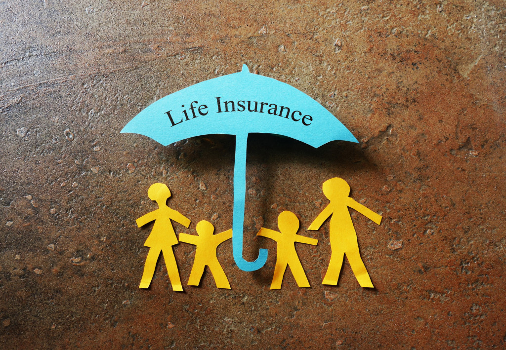 paper family of four under life insurance umbrella