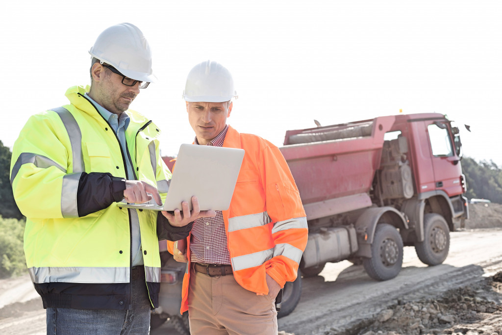 Architect showing the building plans to an engineer. 