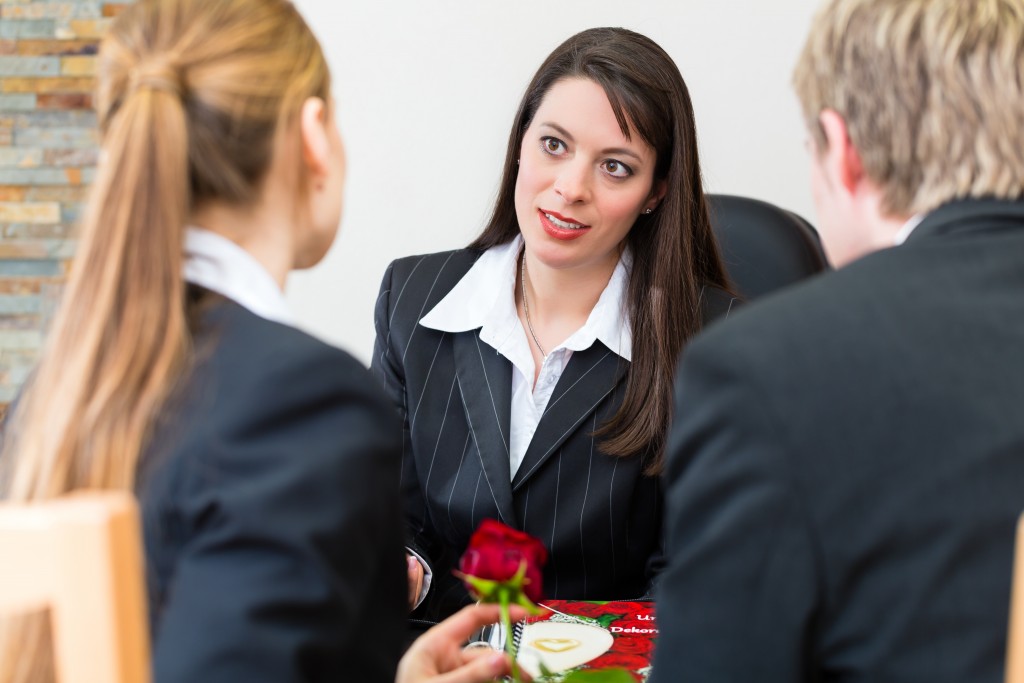 woman talking to 2 people