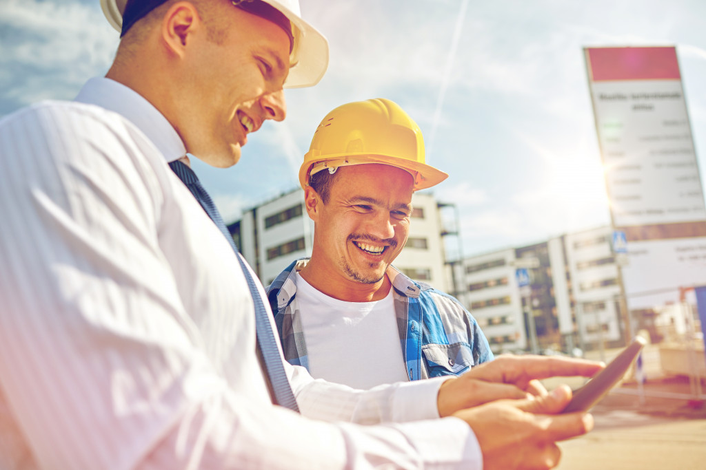 A manager showing something on a tablet to a worker