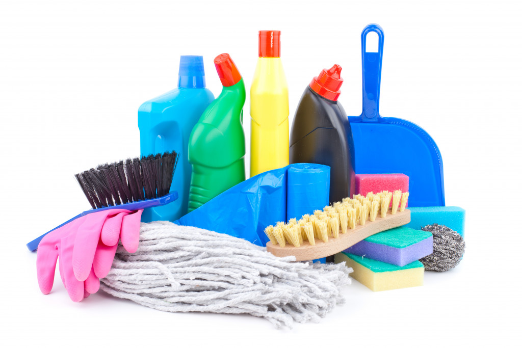 Various cleaning supplies on white background