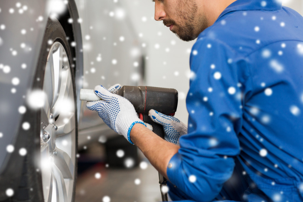 mechanic at auto shop replacing tires