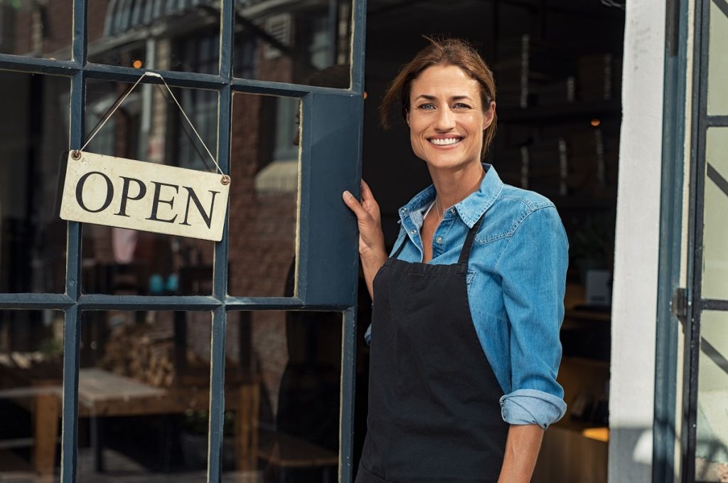businesswoman standing at the entrance of restaurant