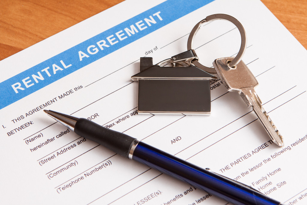 Rental Agreement document with pen and house key