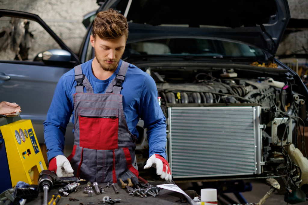 male mechanic at work using tools