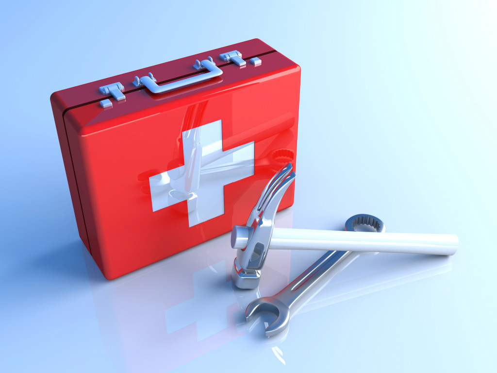 a red box with cross on it, first aid kit