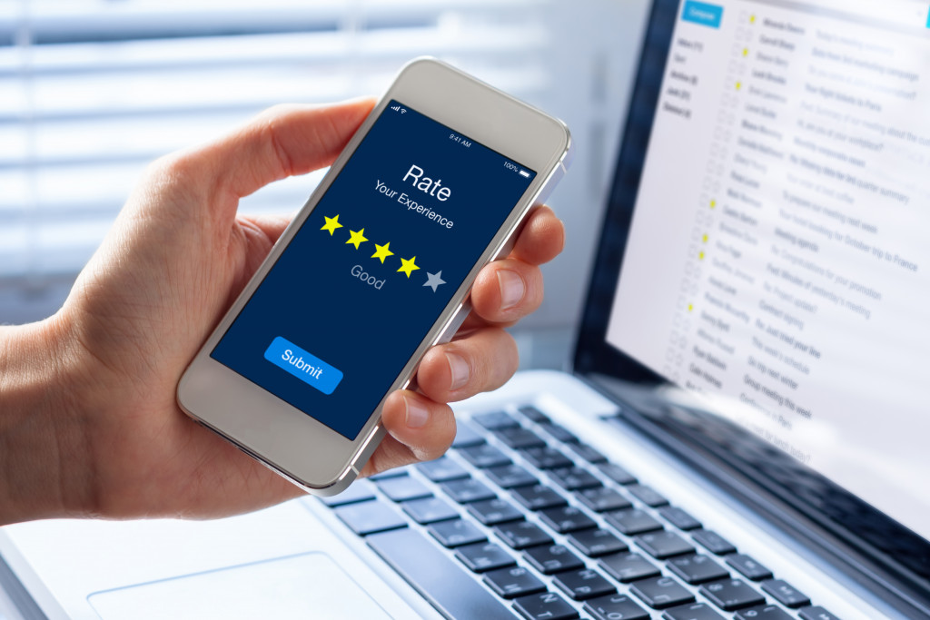 A person leaving a 4 star rating using a smartphone