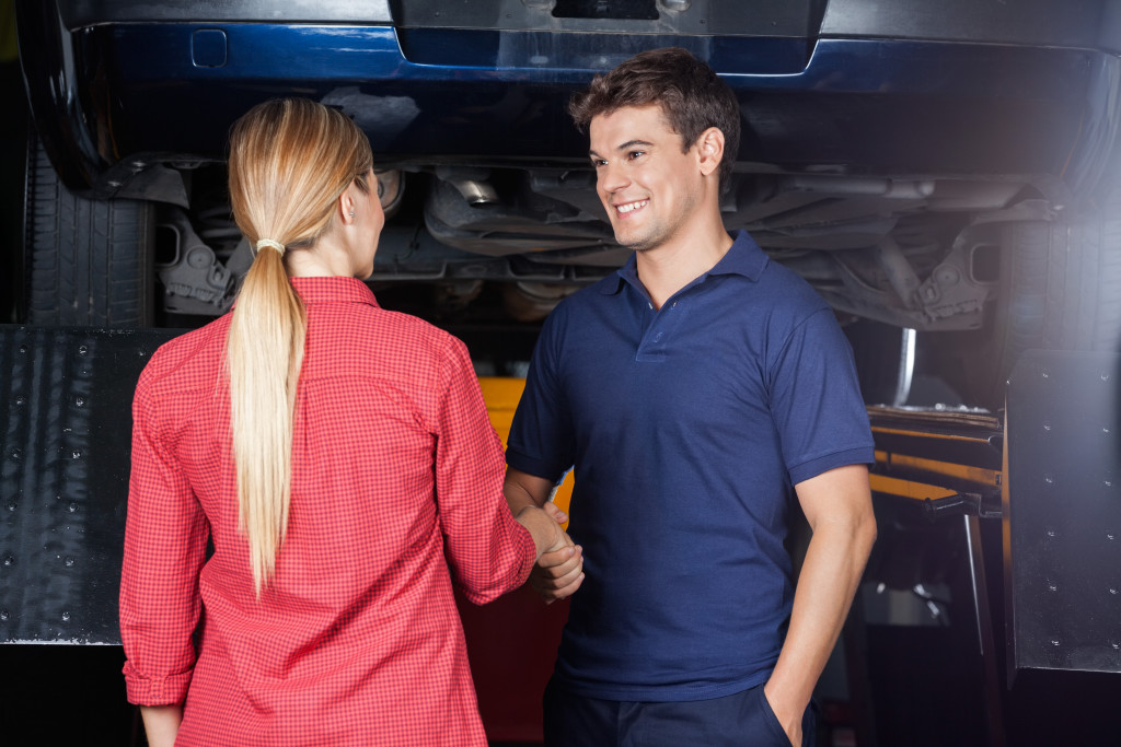 A mechanic talking to a customer in the workshop