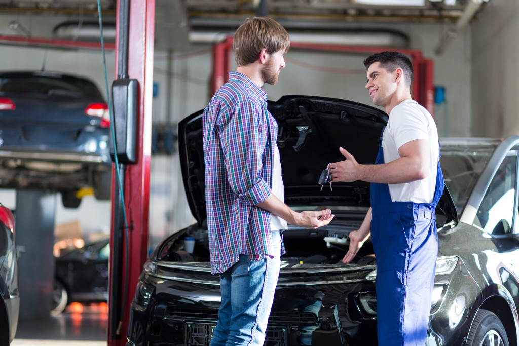 mechanic talking to the car owner