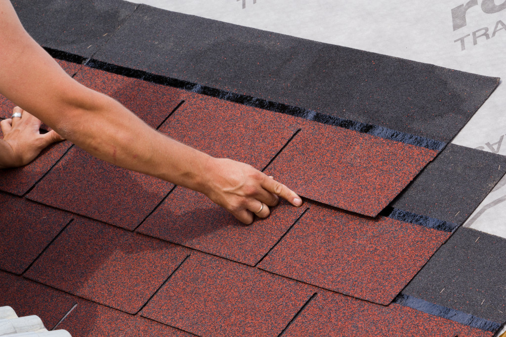 man applying roof material 