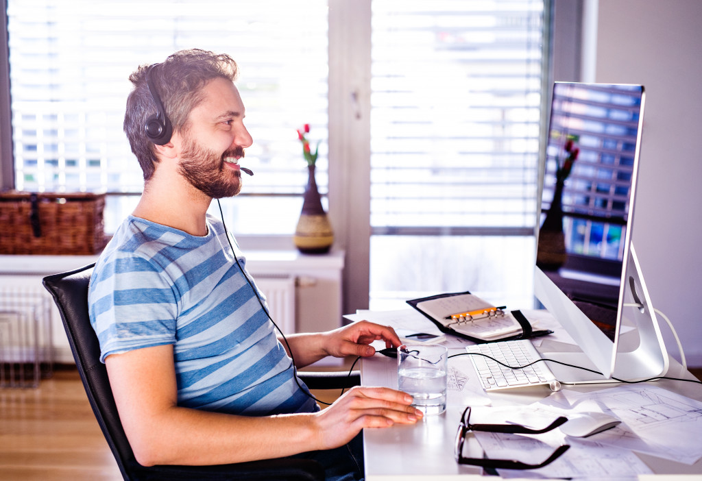 man smiling while working at home