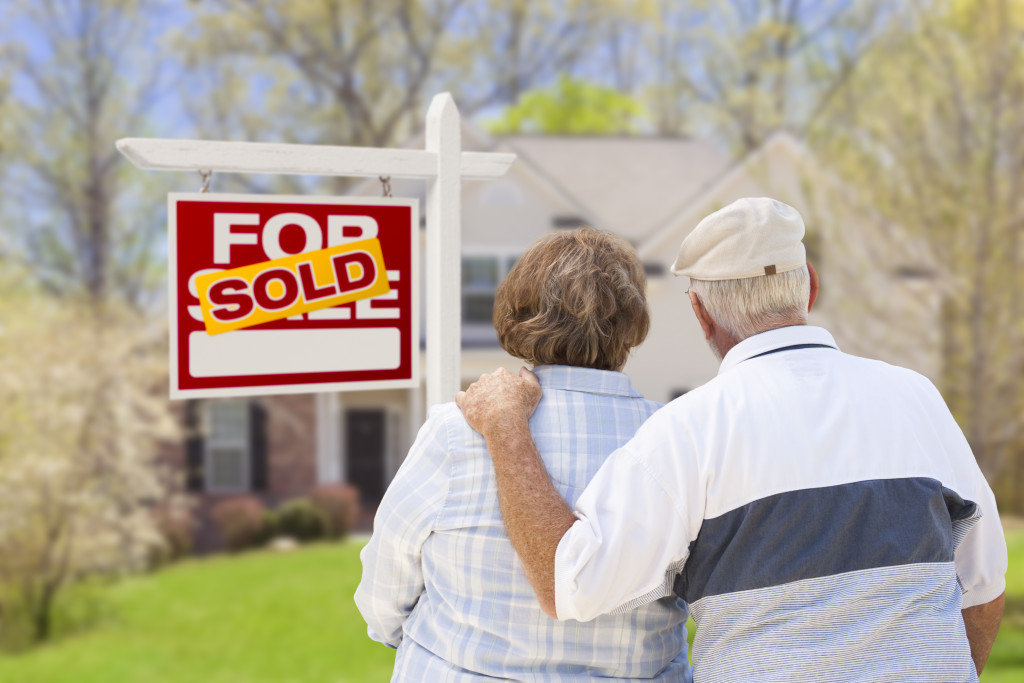 senior couple looking at the sold house