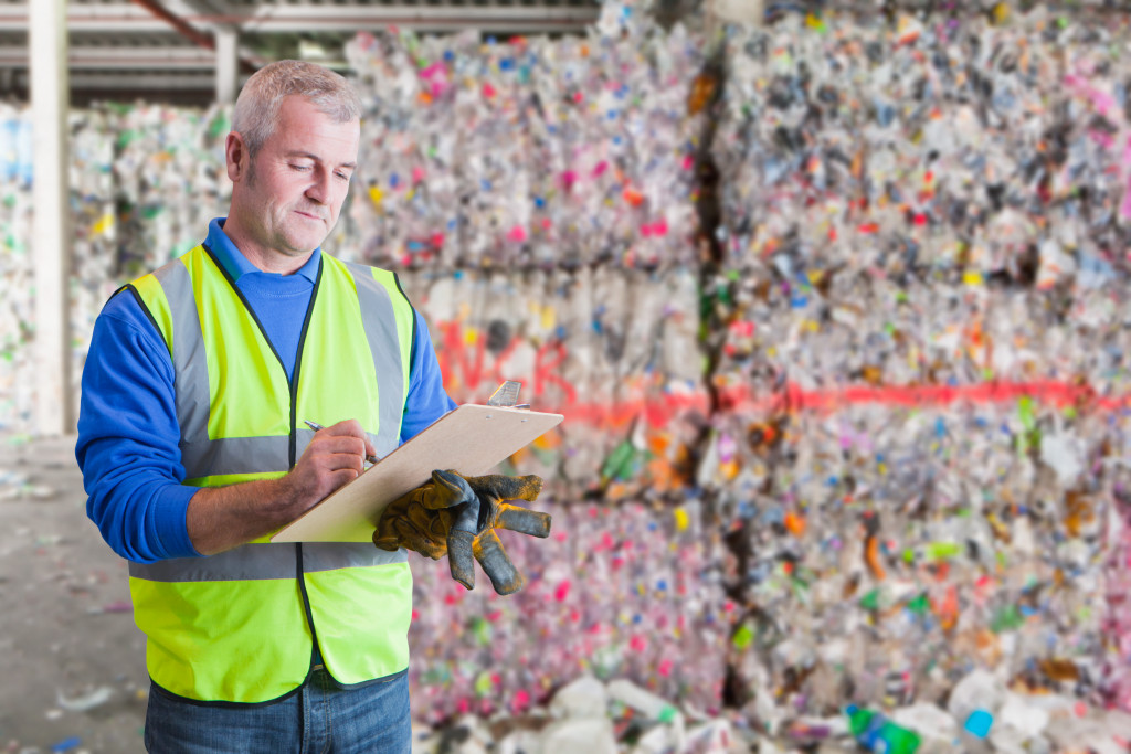 a man taking notes to manage waste