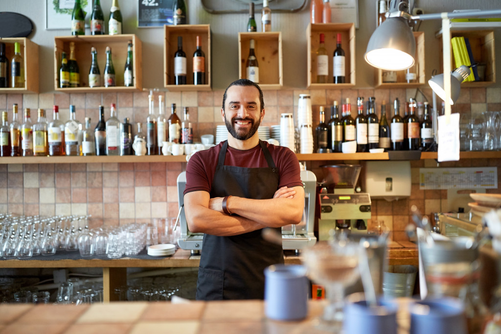 A coffee shop owner smiling to the camera