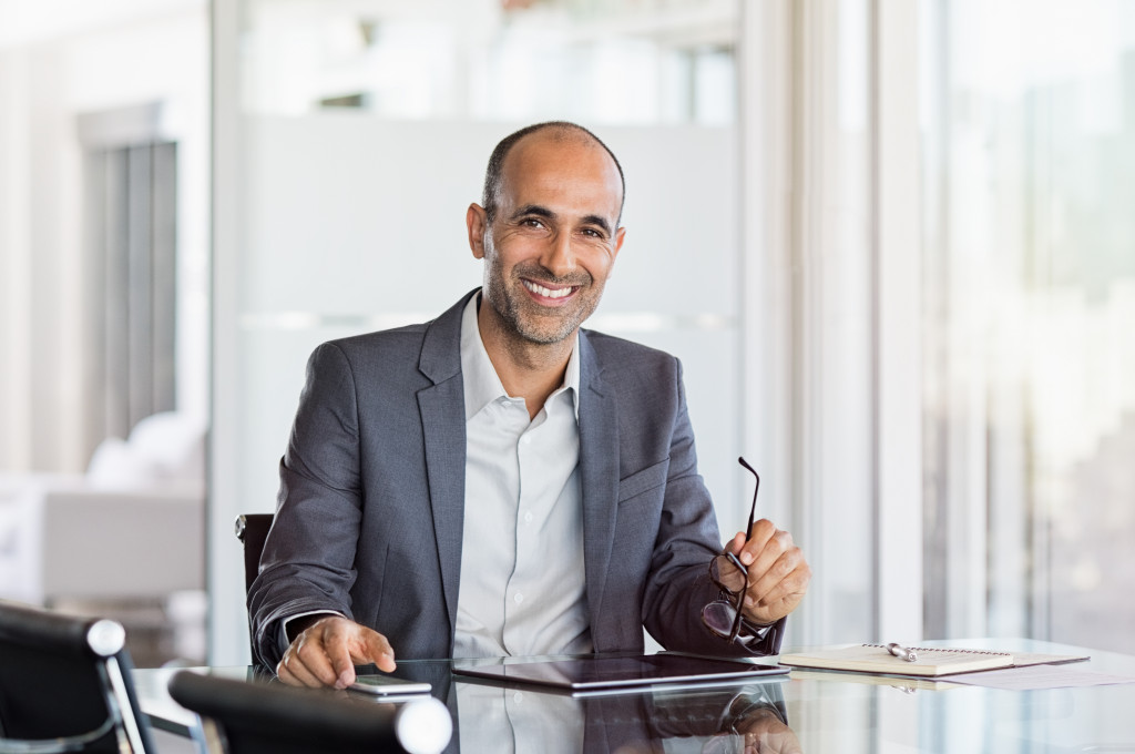 a businessman smiling on this office