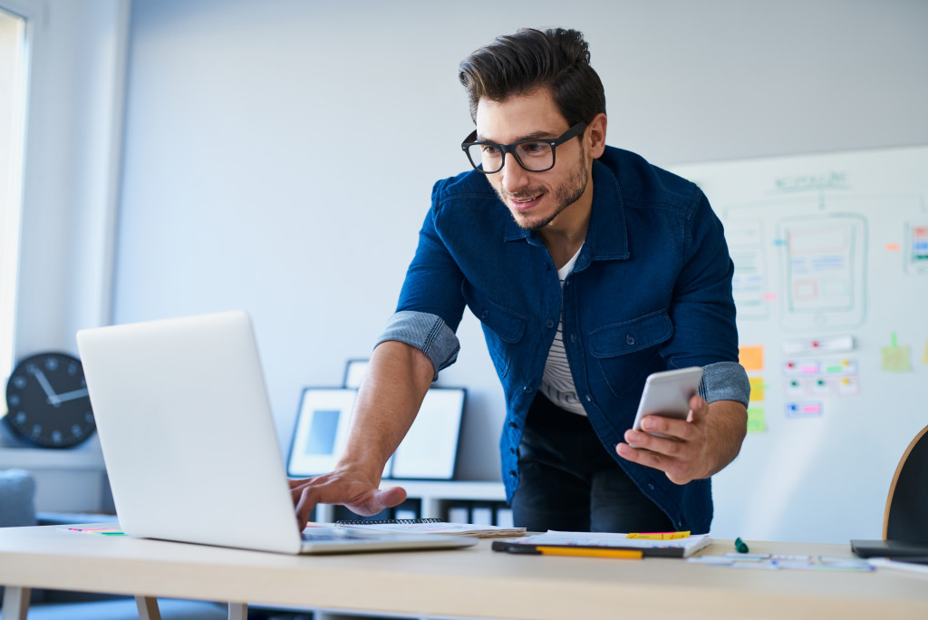 man in glasses developing a business app