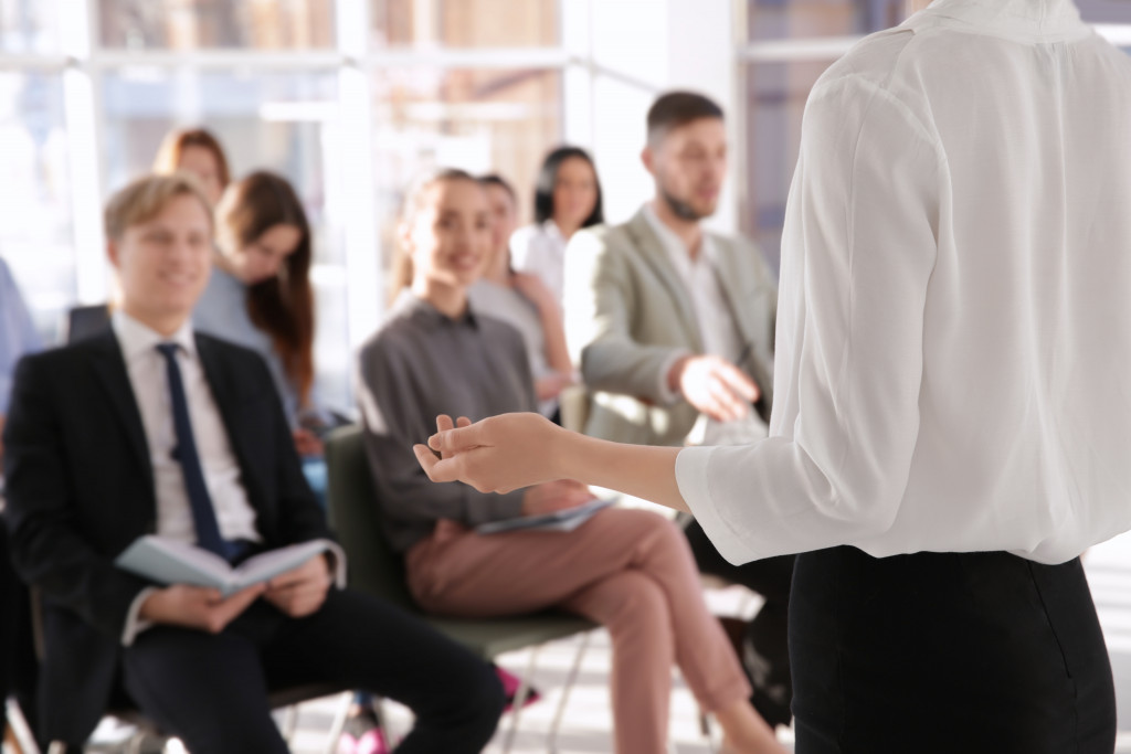 person speaking in seminar or training