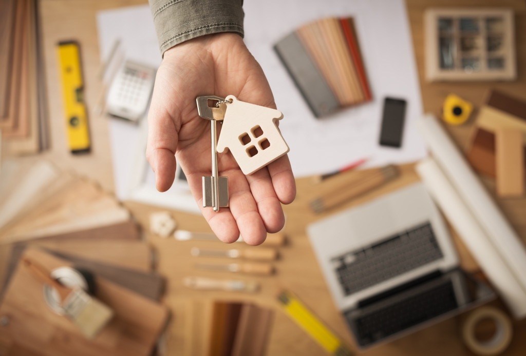 home remodeling contractor with person handing out house key