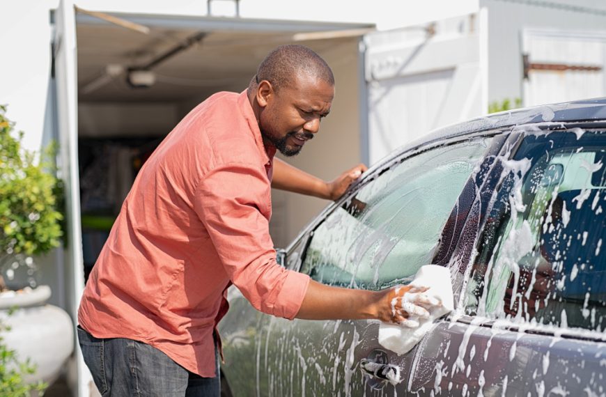 man cleaning his car