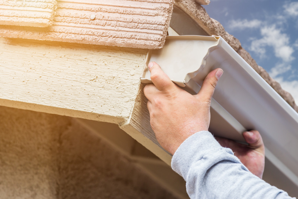 A person repairing a gutter