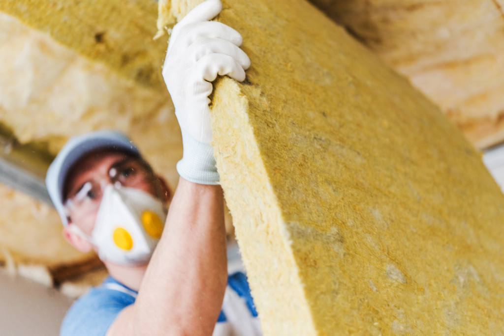 A worker installing insulation