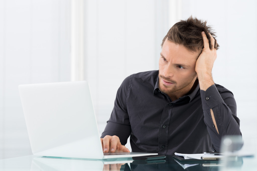 a man feeling stressed working