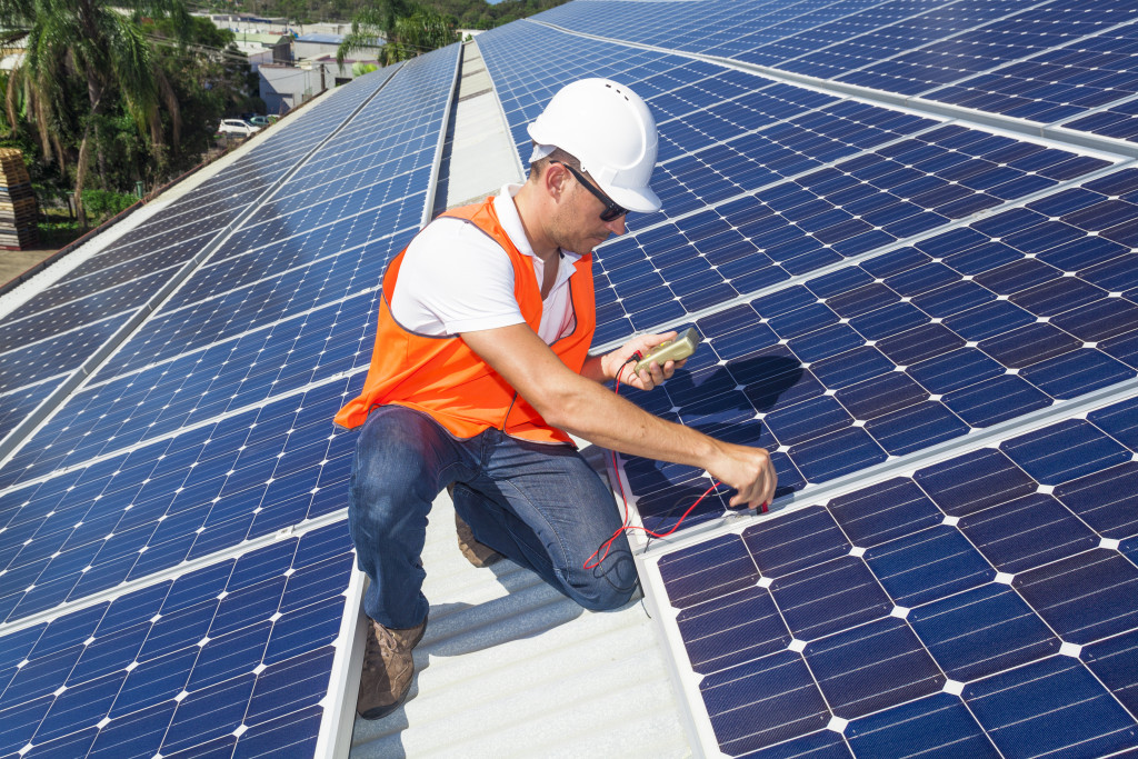 A technician checking solar panels