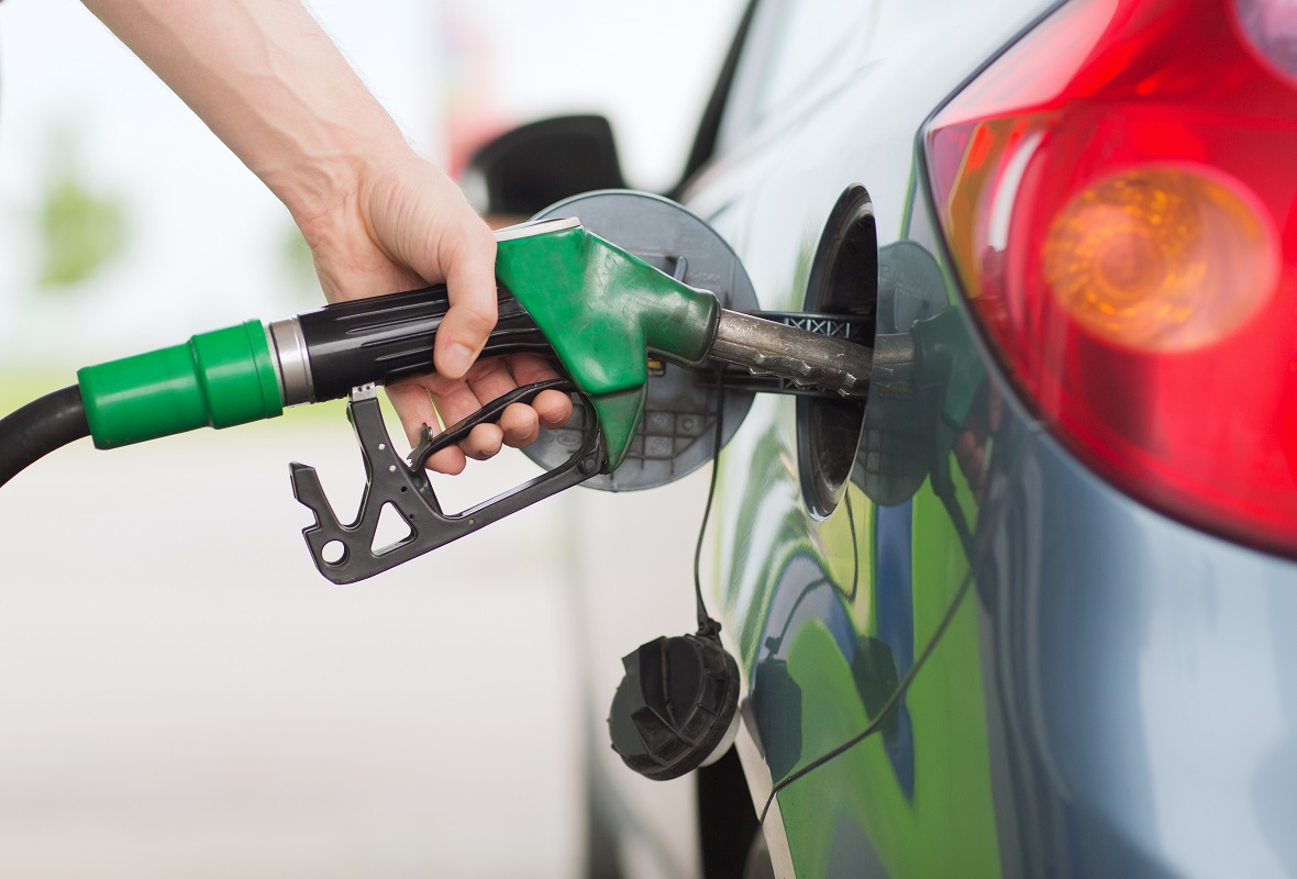 man pumping gasoline fuel in car